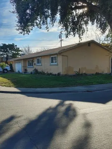 a front view of house with yard and green space
