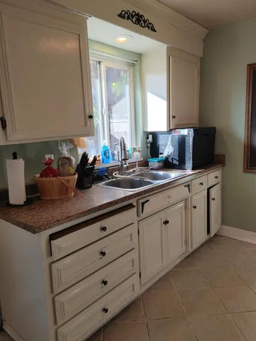 a kitchen with cabinets appliances a sink and a counter top