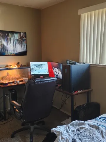 a bed sitting in a bedroom next to a window