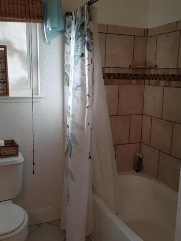 a bathroom with a shower a toilet and a sink