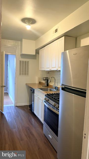 1424 Staples Street Northeast, Unit 1 Washington, DC 20002 - Photo 3 of 8 a white refrigerator freezer sitting inside of a kitchen