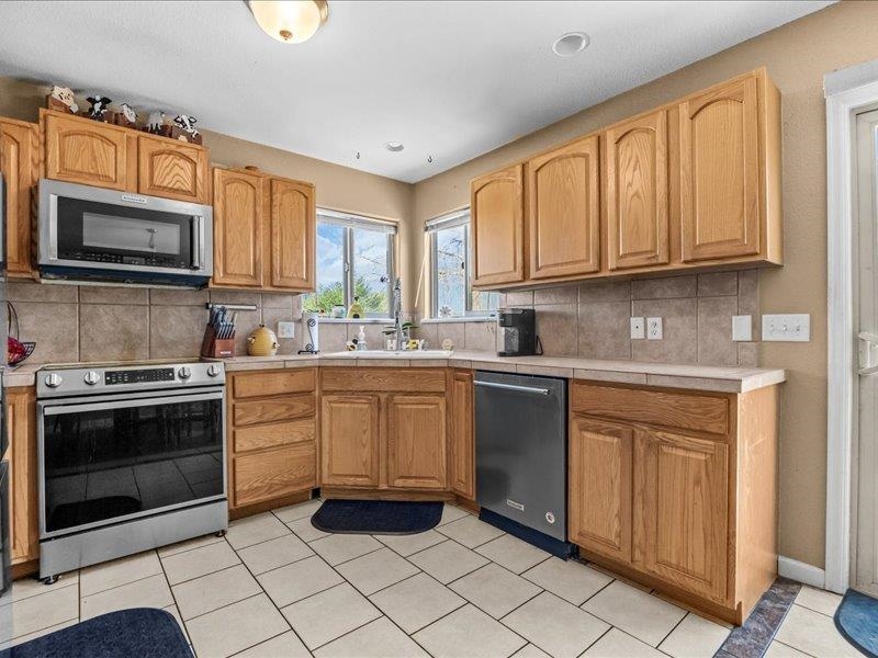 2860 B B 3/4 Road Grand Junction, CO 81503 - Photo 12 of 29 a kitchen with stainless steel appliances granite countertop a stove microwave and sink