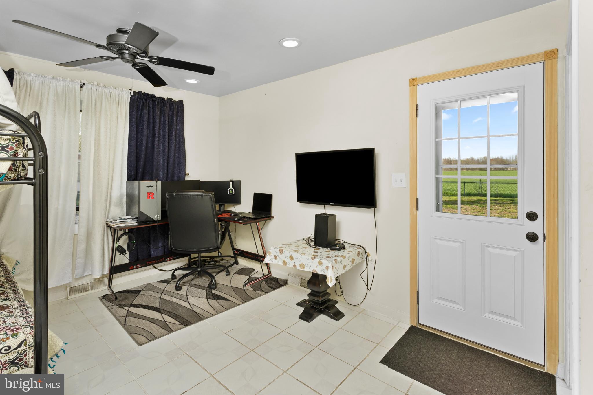 59 Bordentown Chesterfield Road Chesterfield, NJ 08515 - Photo 21 of 50 a view of a workspace with furniture and a flat screen tv