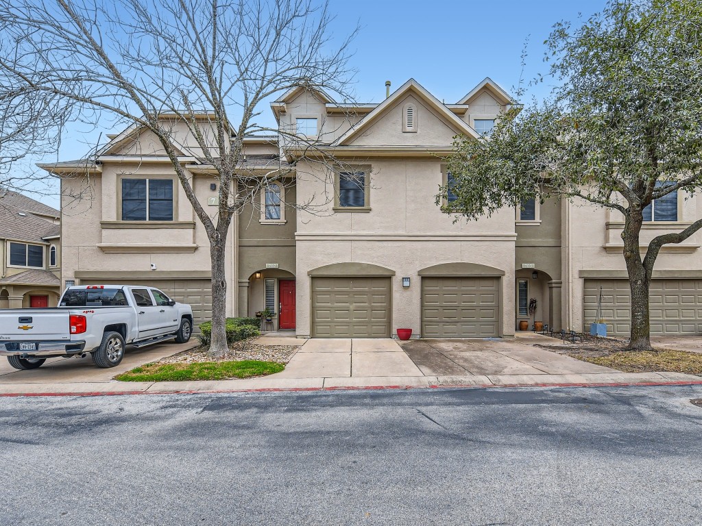 11203 Ranch Road 2222, Unit 702 Austin, TX 78732 - Photo 1 of 1 a view of multiple houses with yard and parking