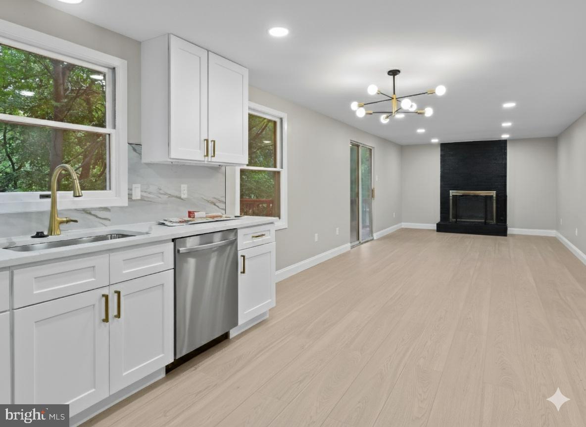 3317 Grayvine Lane Bowie, MD 20721 - Photo 11 of 36 a kitchen with kitchen island granite countertop a sink window and cabinets