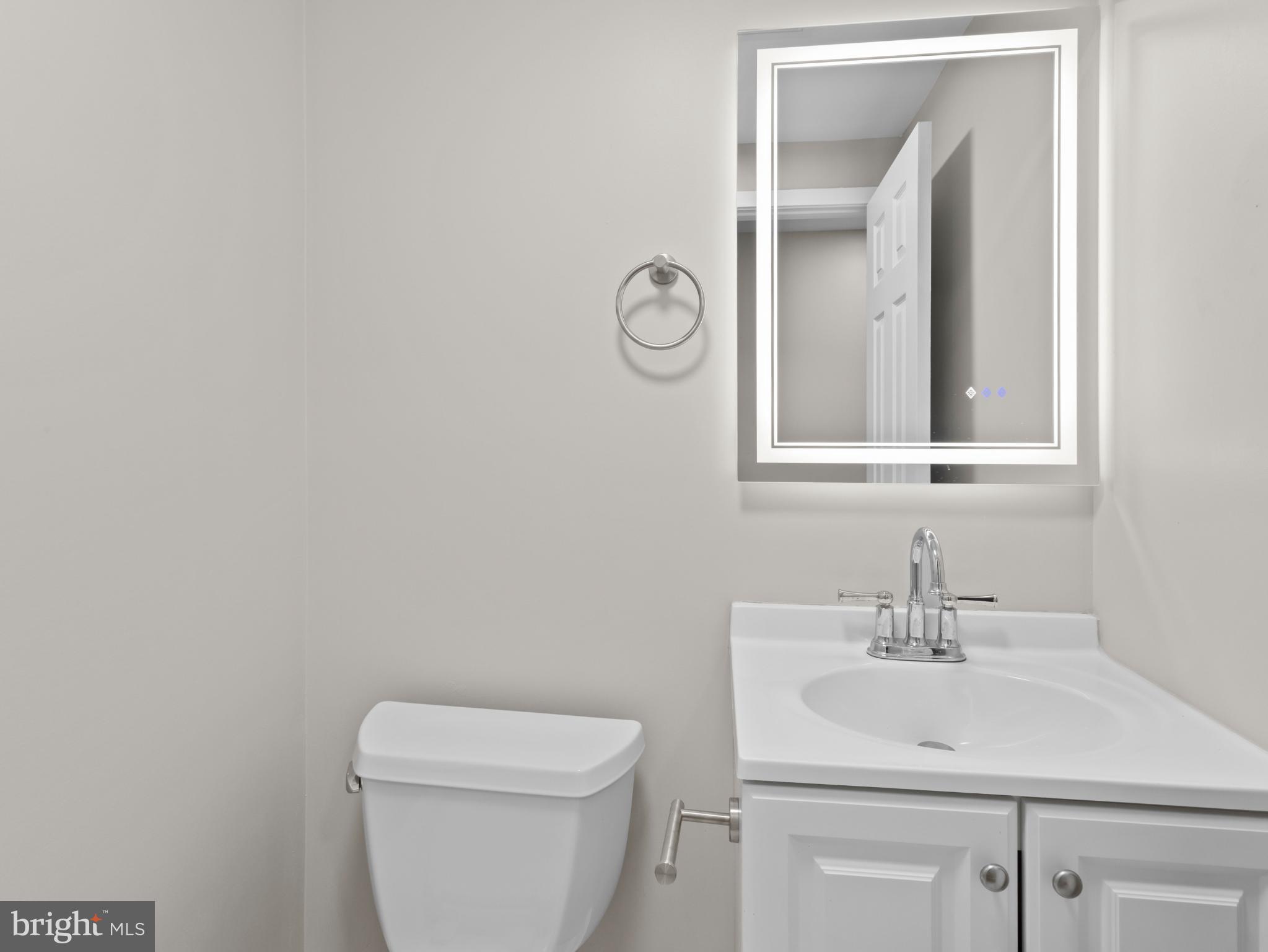 3317 Grayvine Lane Bowie, MD 20721 - Photo 13 of 36 a bathroom with a toilet a sink and mirror