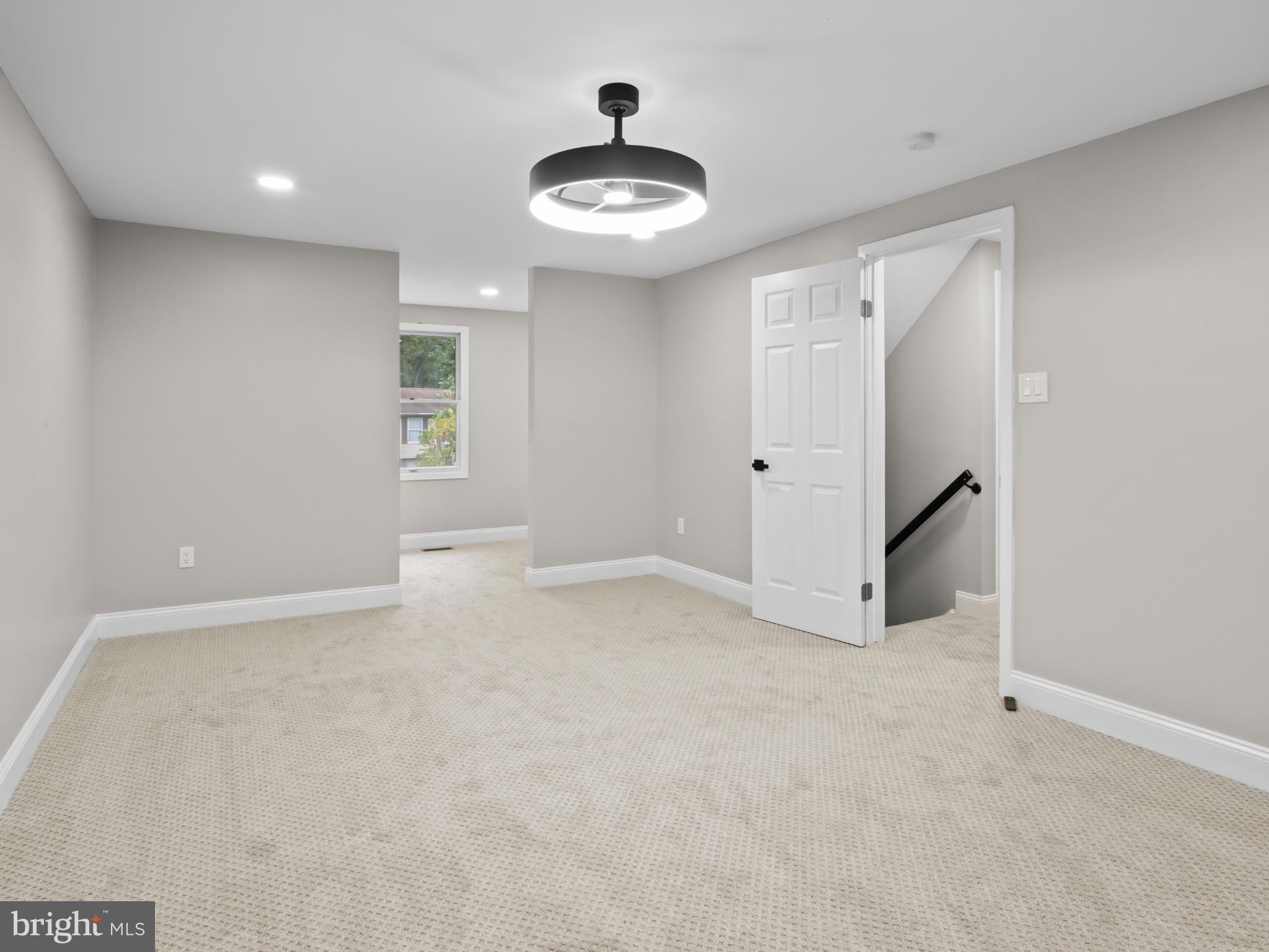 3317 Grayvine Lane Bowie, MD 20721 - Photo 14 of 36 an empty room with chandelier fan and windows