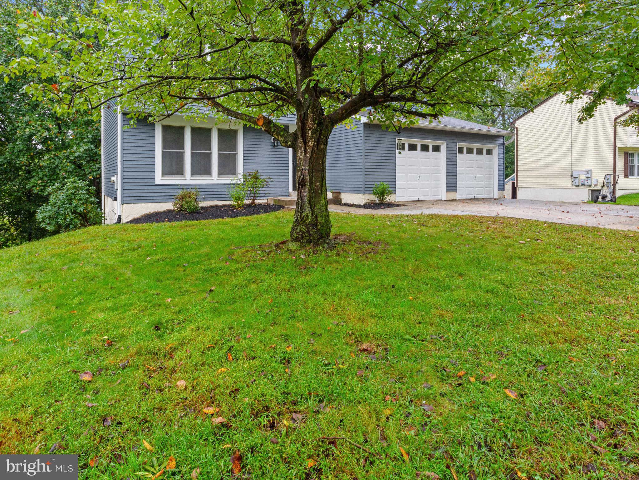 3317 Grayvine Lane Bowie, MD 20721 - Photo 3 of 36 a front view of a house with a yard and trees