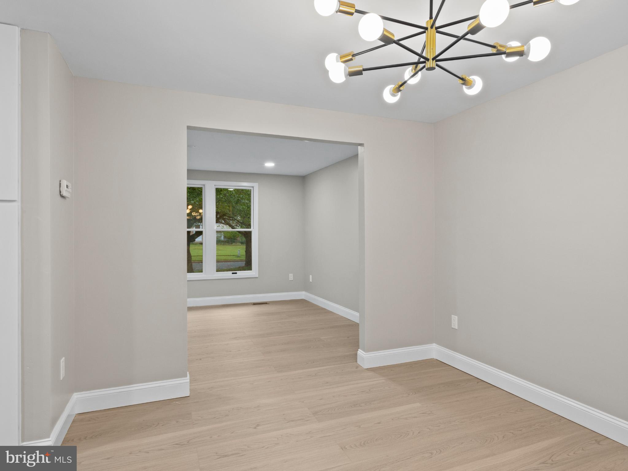 3317 Grayvine Lane Bowie, MD 20721 - Photo 7 of 36 an empty room with wooden floor fan and windows
