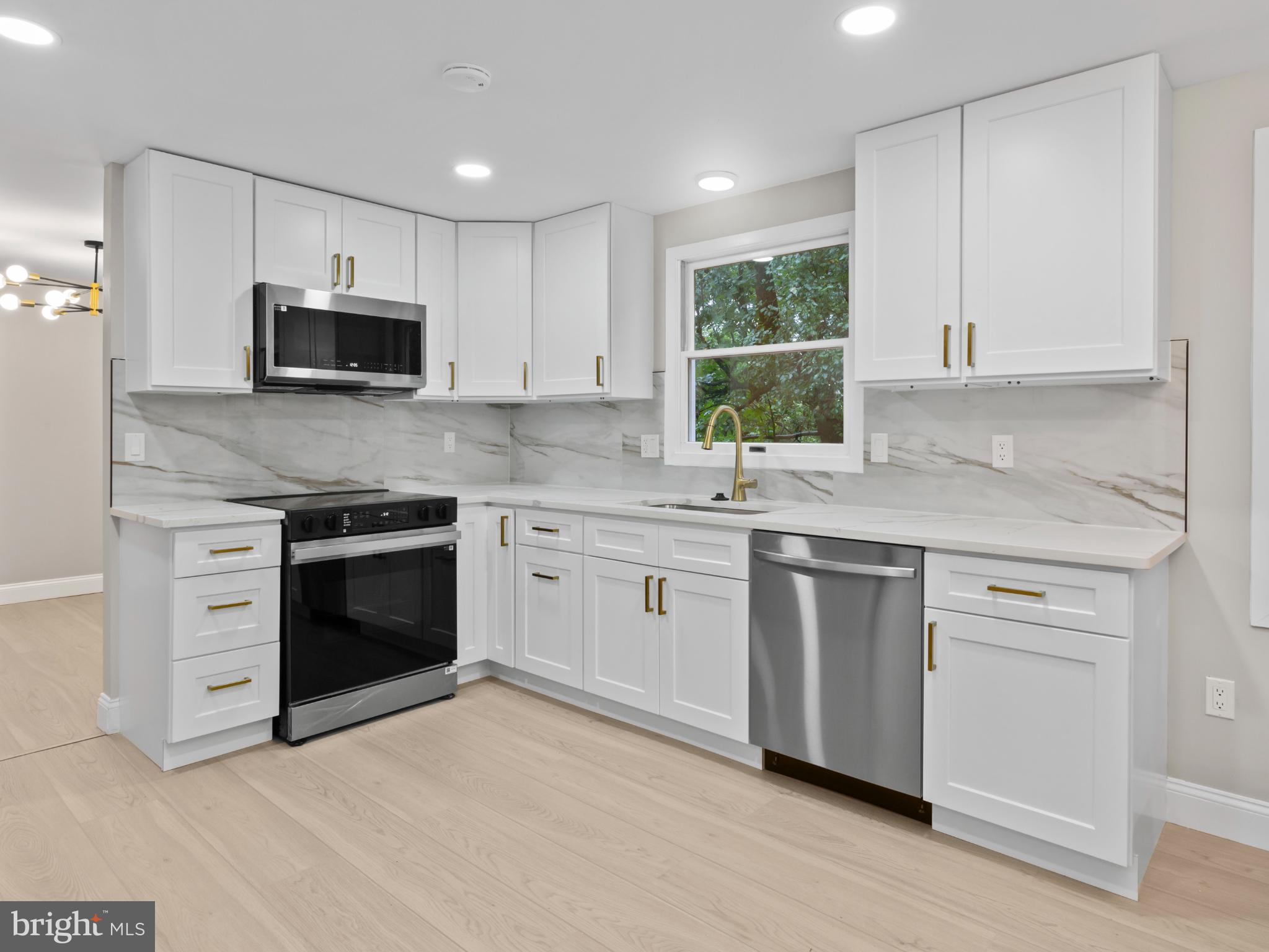 3317 Grayvine Lane Bowie, MD 20721 - Photo 10 of 36 a kitchen with stainless steel appliances granite countertop a stove a sink and a microwave