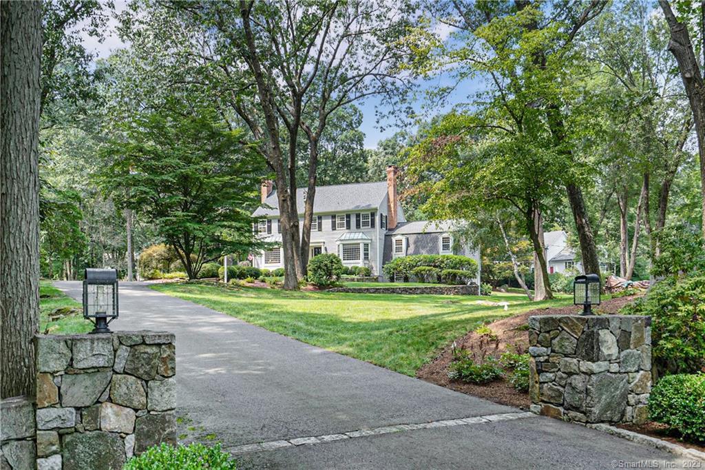 95 Pipers Hill Road Wilton, CT 06897 - Photo 1 of 1 a view of a big house with a big yard and large trees