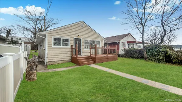 a view of a house with a yard and sitting area