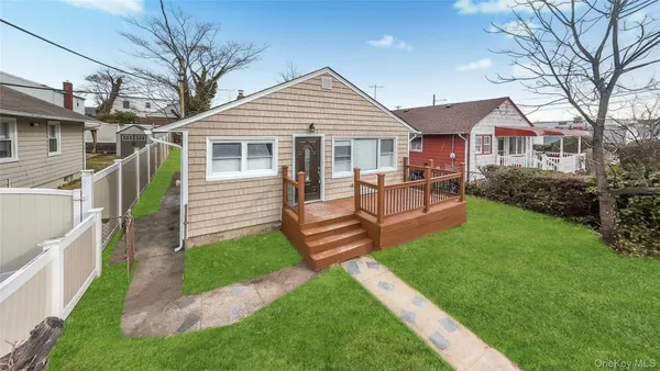 a front view of a house with a garden and patio