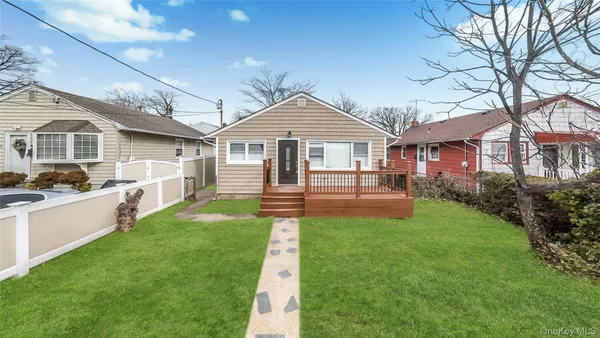 a front view of a house with a garden and yard