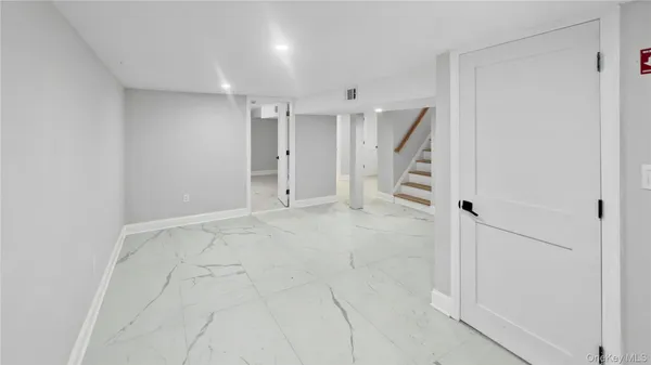 a bathroom with a granite countertop toilet and a sink