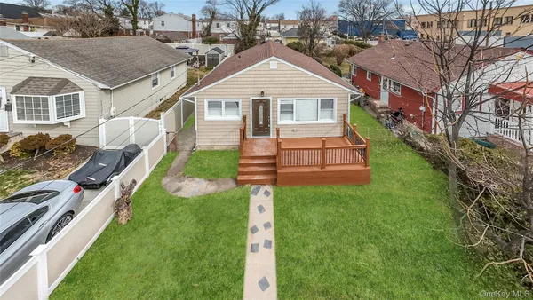 a front view of a house with a yard table and chairs