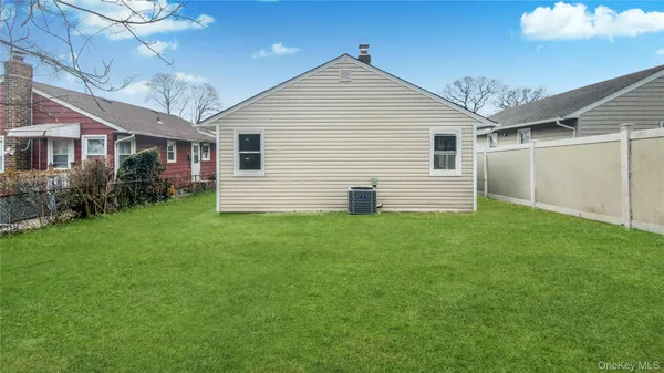 a view of a backyard with plants and large tree