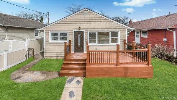 a view of a house with a yard and deck