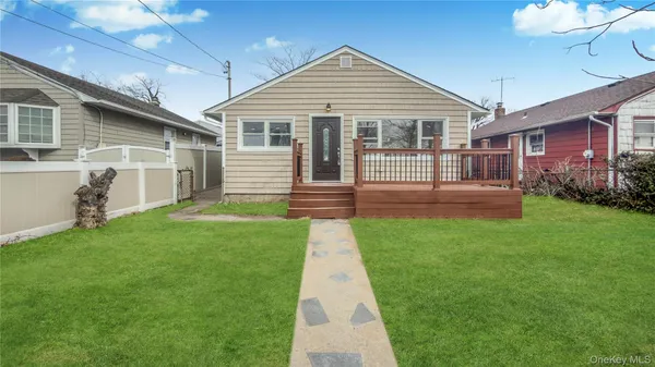 a front view of a house with a yard and garden