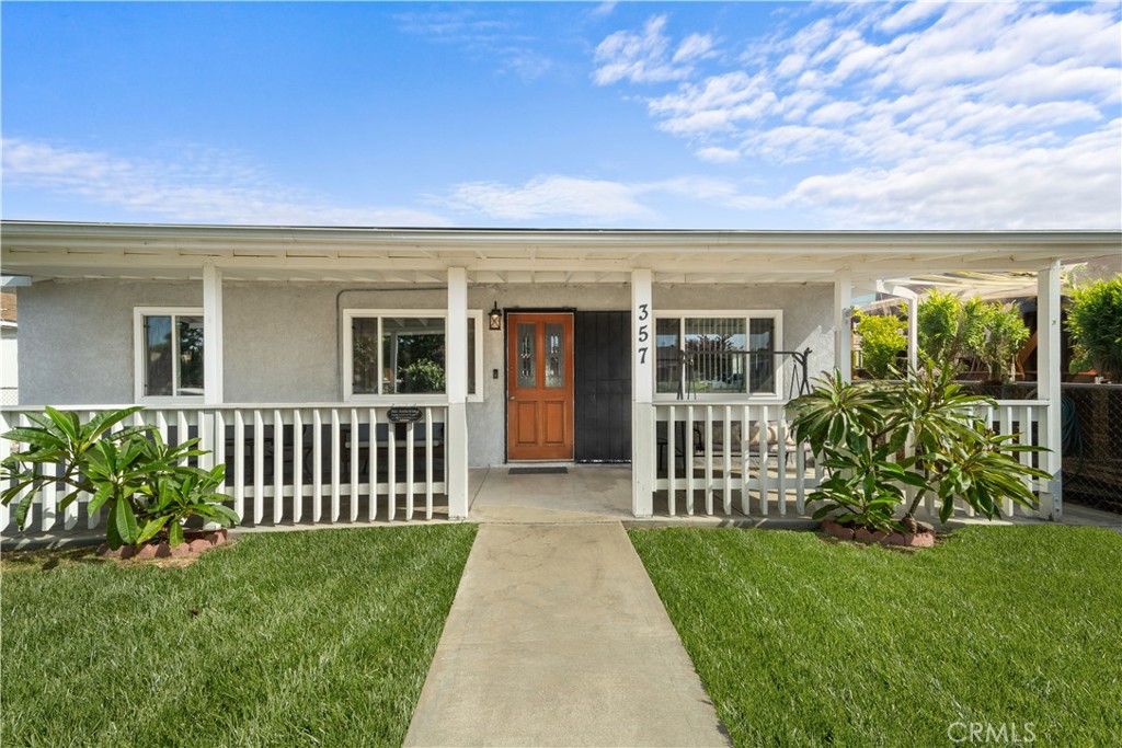 a porch with a table and chairs