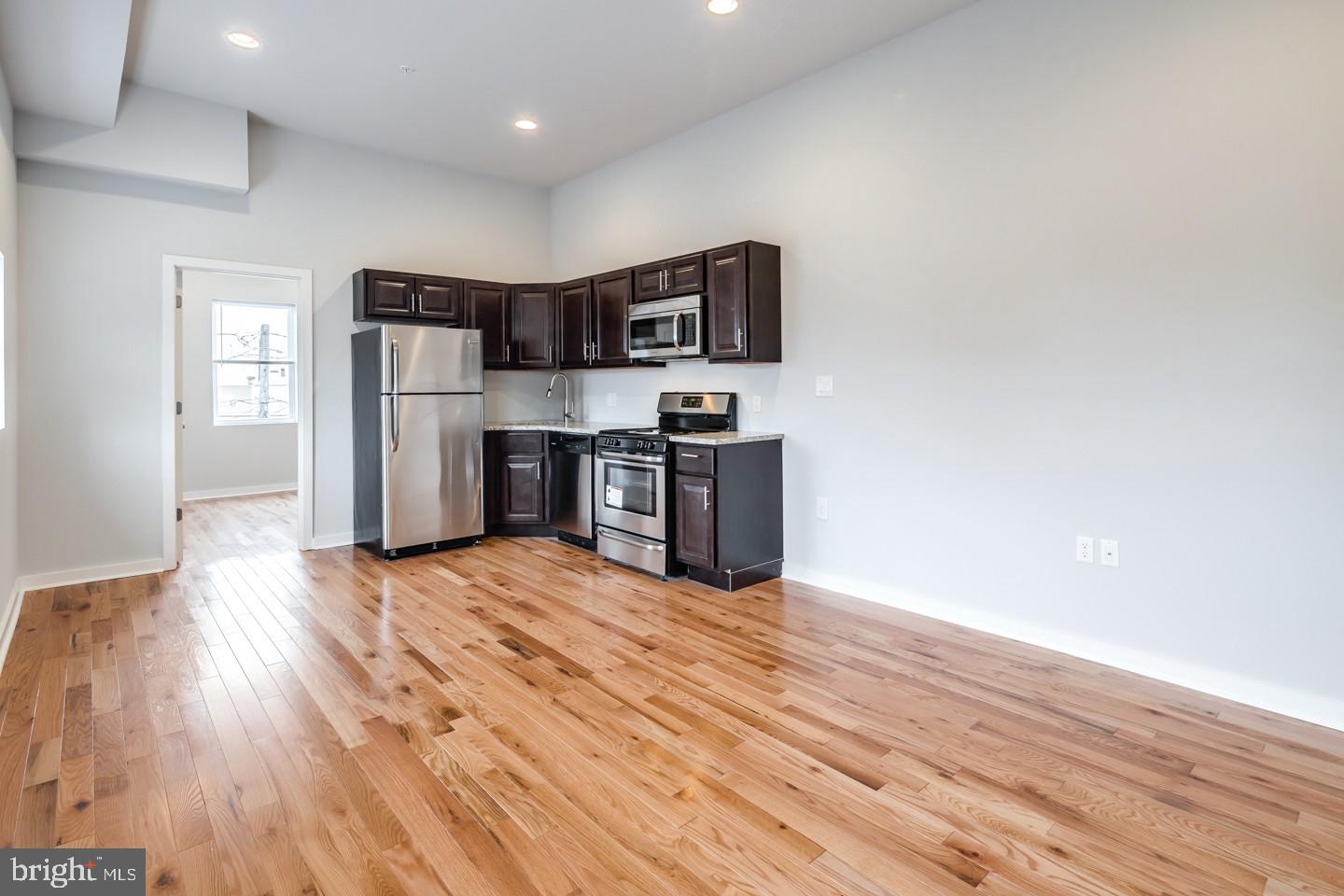 2221 South Broad Street, Unit 2R Philadelphia, PA 19148 - Photo 1 of 7 a view of kitchen with stainless steel appliances wooden floor and large window