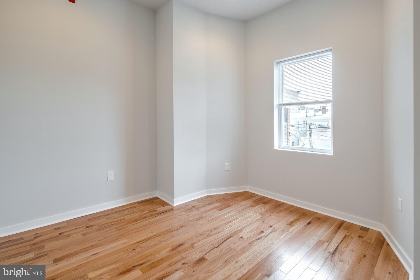 2221 South Broad Street, Unit 2R Philadelphia, PA 19148 - Photo 4 of 7 a view of a room with wooden floor and windows