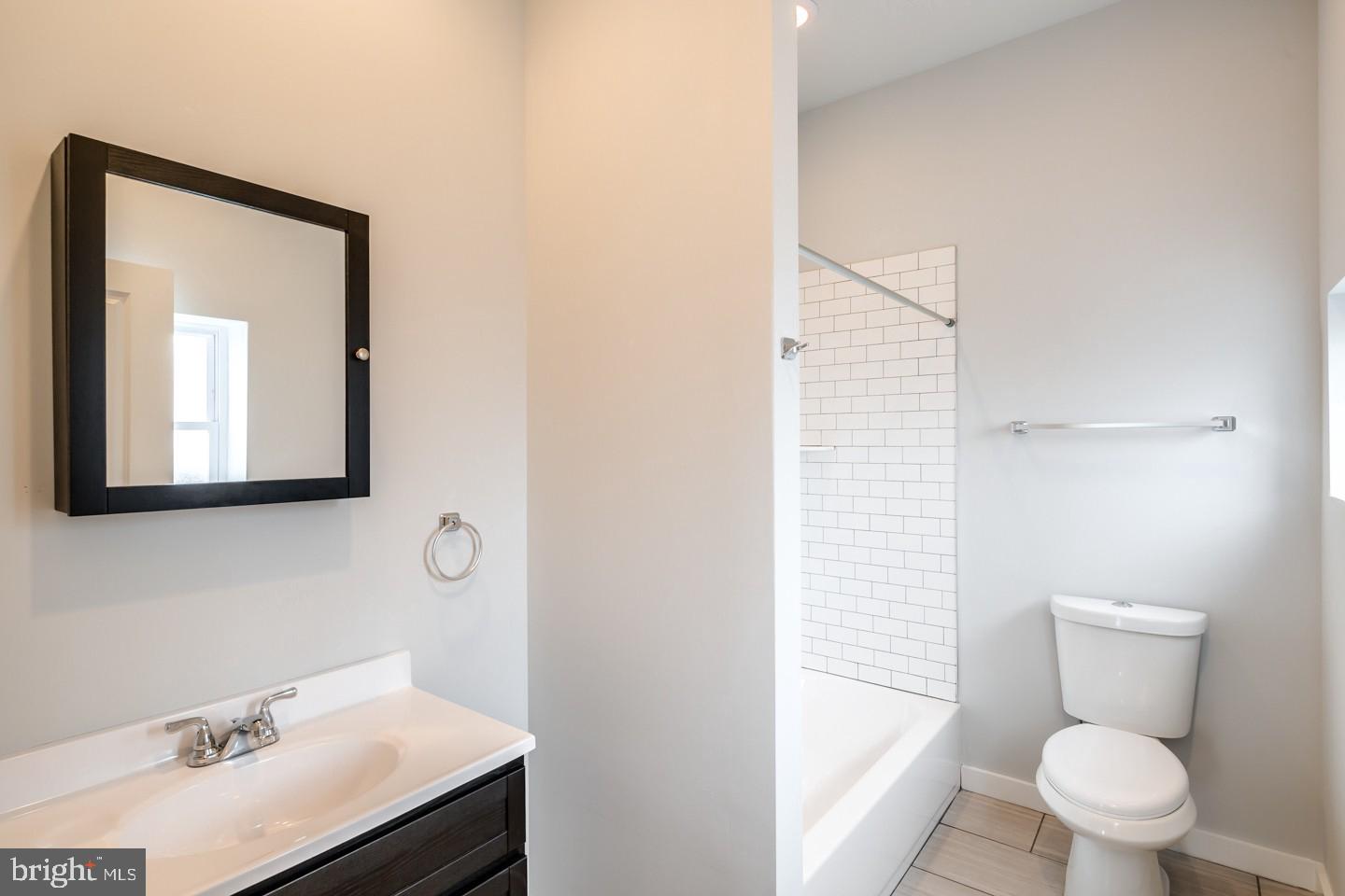 2221 South Broad Street, Unit 2R Philadelphia, PA 19148 - Photo 5 of 7 a bathroom with a sink toilet and shower