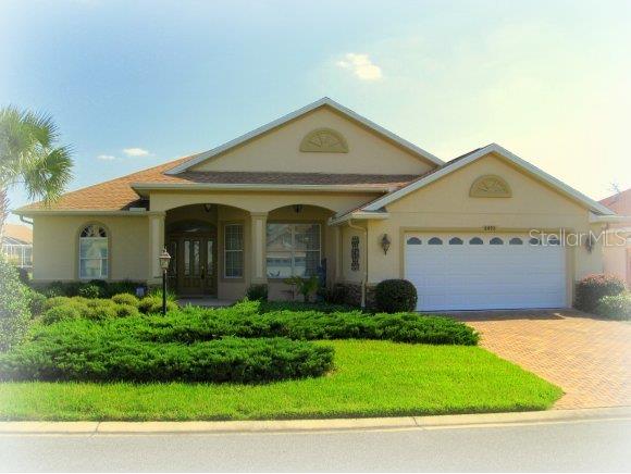 8495 Southwest 84th Loop Ocala, FL 34481 - Photo 1 of 1 a front view of a house with garden