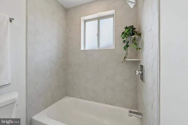 a bath room with a toilet and a shower