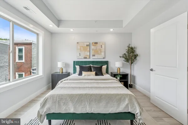 a spacious bedroom with a bed and a large window