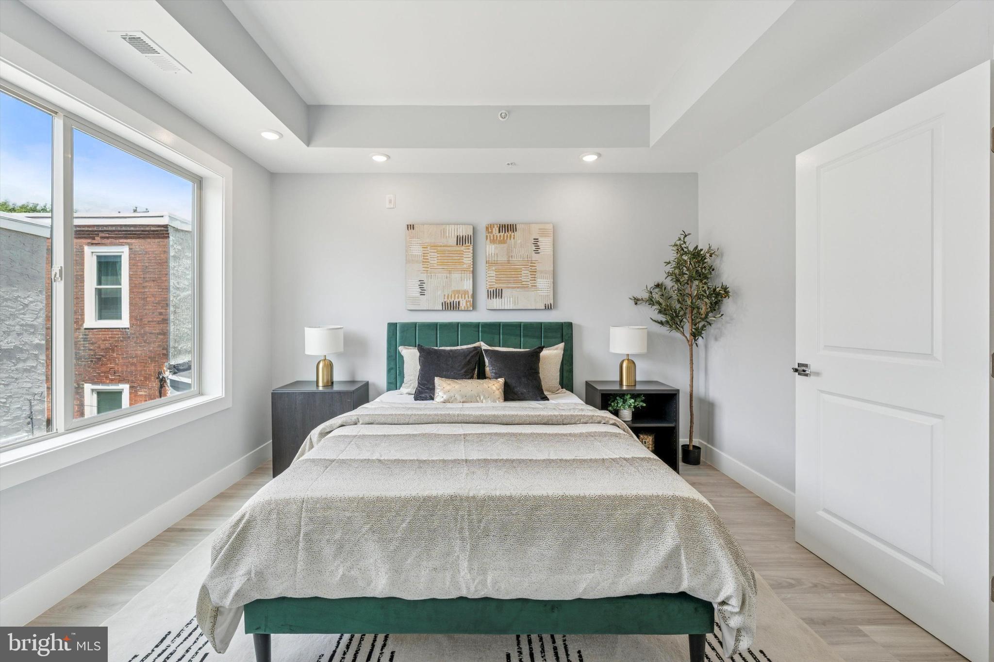 2401 North 2nd Street, Unit D2 Philadelphia, PA 19133 - Photo 23 of 25 a spacious bedroom with a bed and a large window
