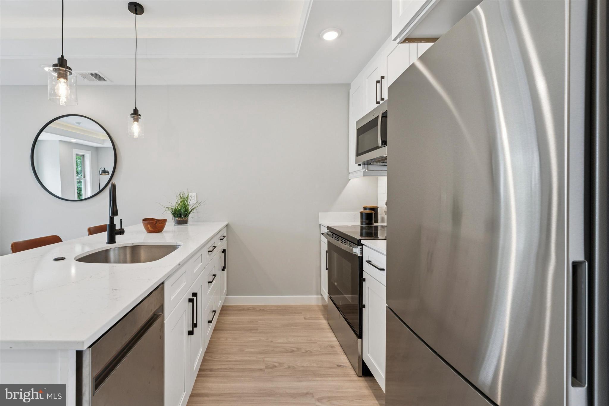 2401 North 2nd Street, Unit D2 Philadelphia, PA 19133 - Photo 4 of 25 a kitchen with sink refrigerator and cabinets
