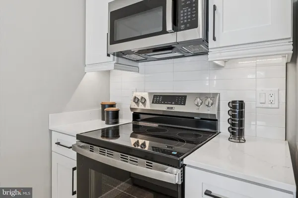 a kitchen with a stove and a microwave