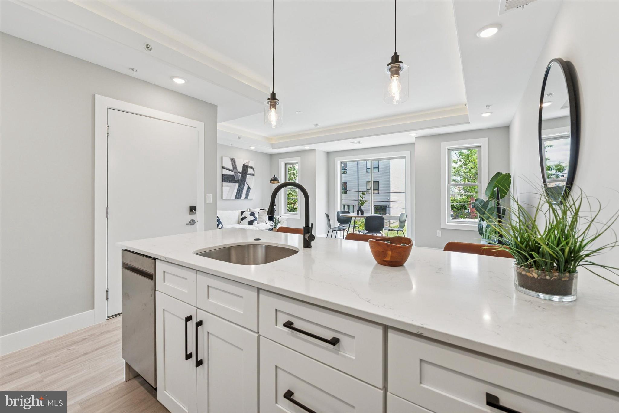 2401 North 2nd Street, Unit D2 Philadelphia, PA 19133 - Photo 7 of 25 a kitchen with stainless steel appliances a sink a potted plant and windows