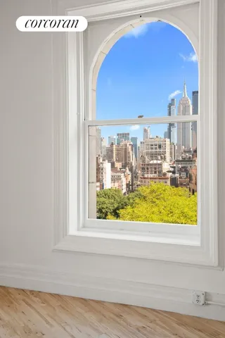 a vase of flowers sitting on a table with wooden floor