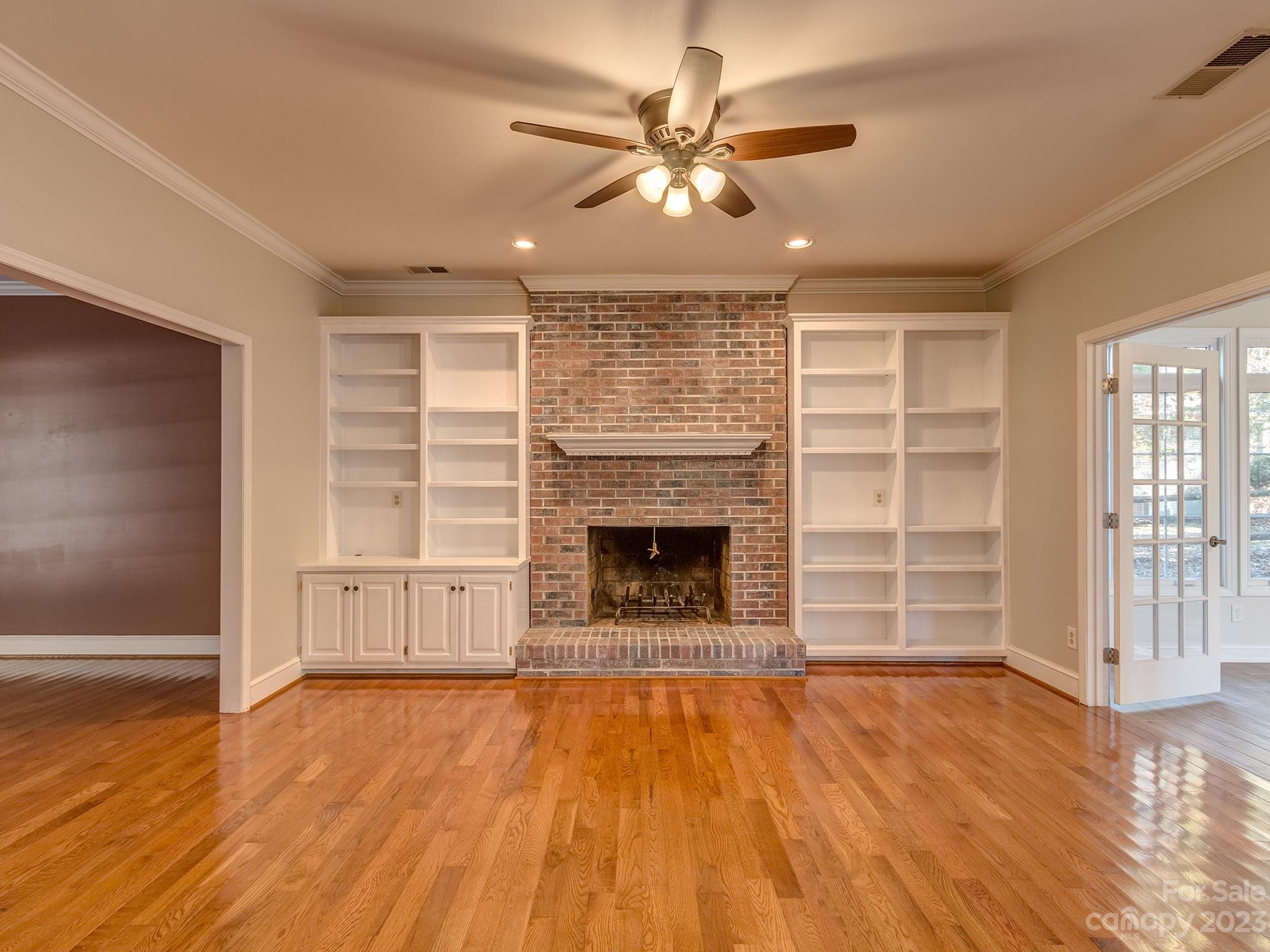 3301 Carnegie Lane Mint Hill, NC 28105 - Photo 2 of 34 an empty room with a fireplace and wooden floor