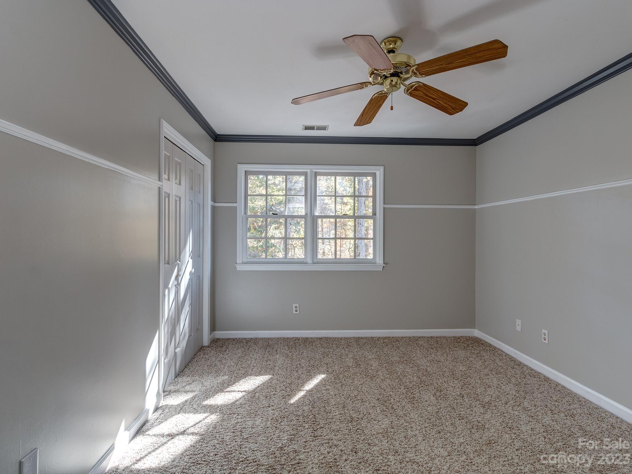 3301 Carnegie Lane Mint Hill, NC 28105 - Photo 25 of 34 an empty room with a ceiling fan and windows