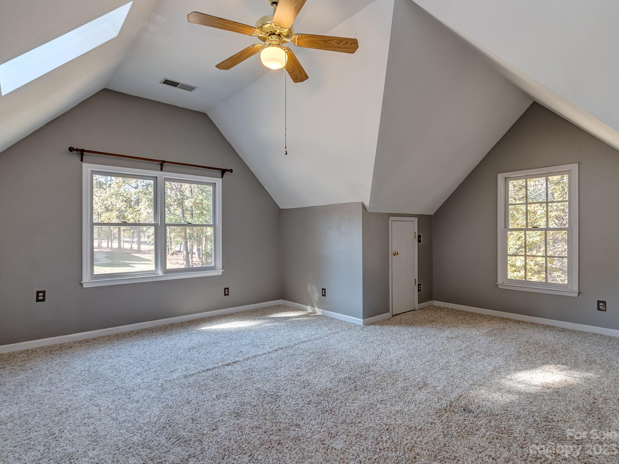 3301 Carnegie Lane Mint Hill, NC 28105 - Photo 28 of 34 a view of a big room with windows and chandelier fan