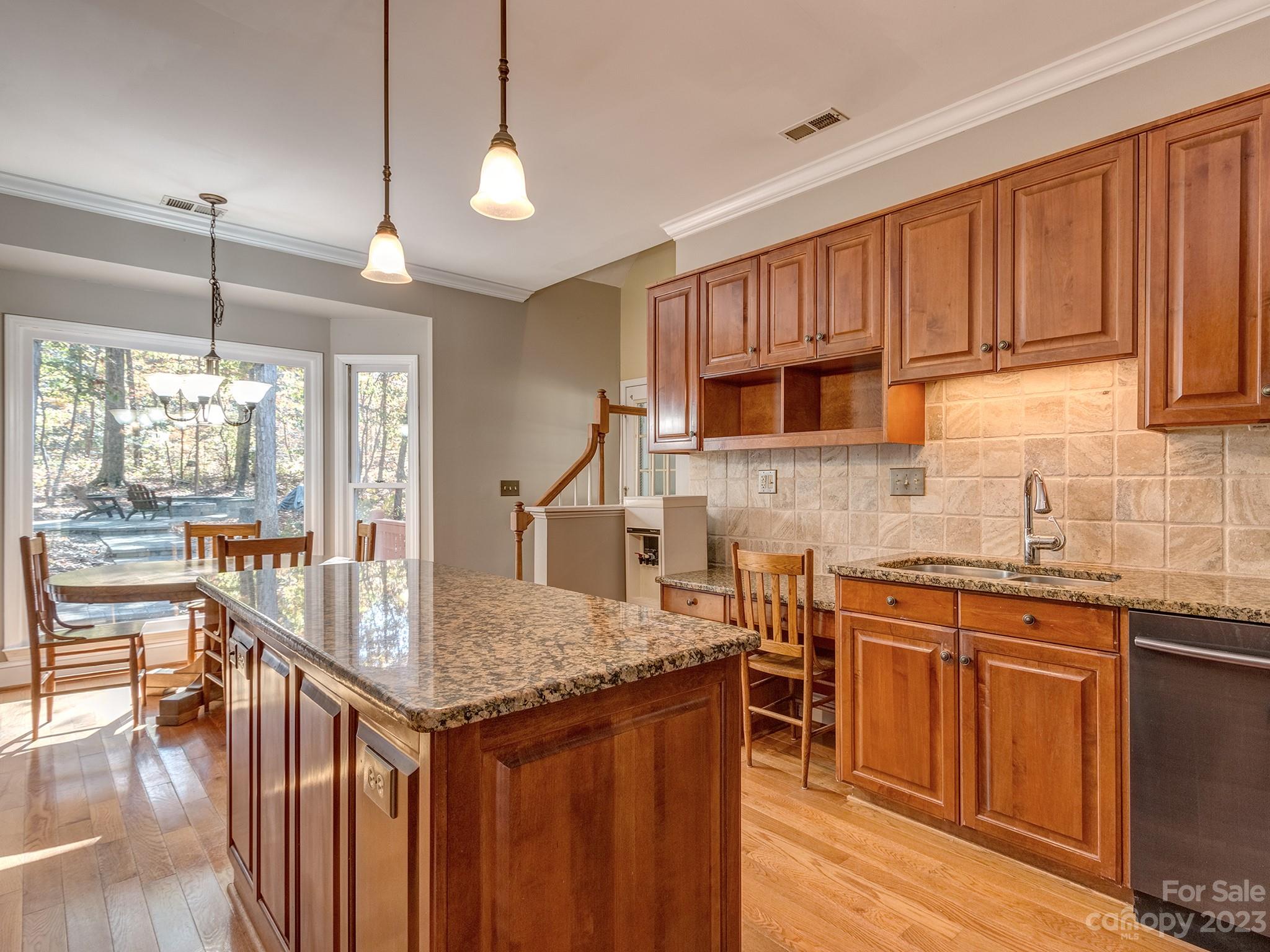 3301 Carnegie Lane Mint Hill, NC 28105 - Photo 4 of 34 a kitchen with granite countertop a stove a sink dishwasher and cabinets with wooden floor