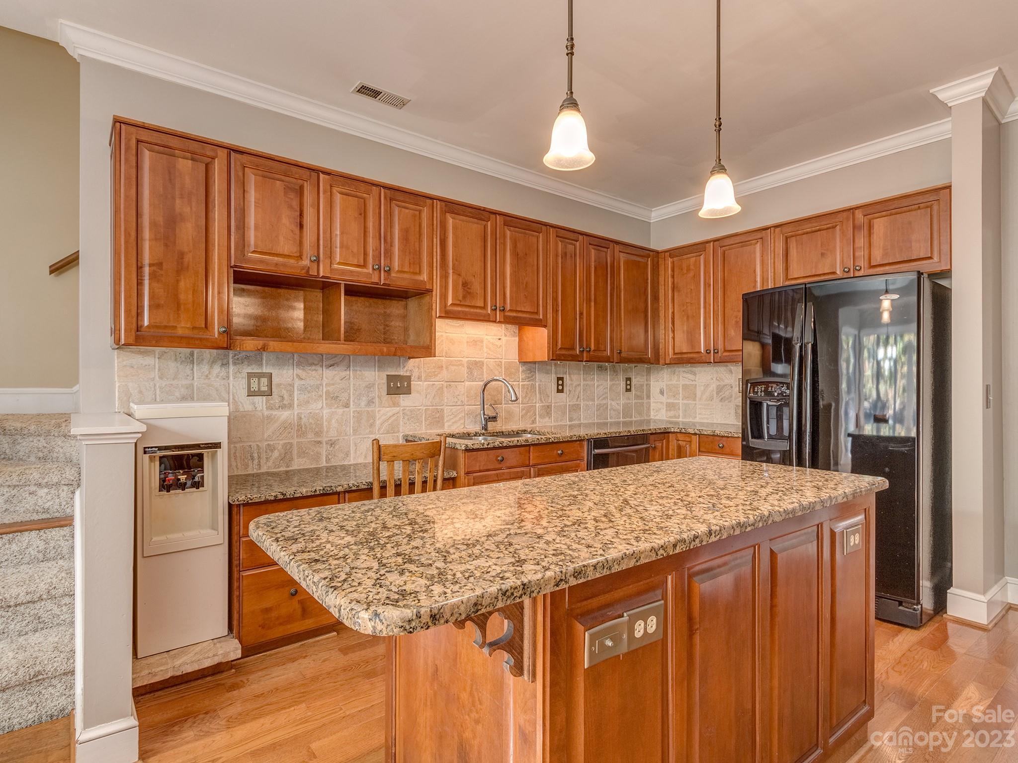 3301 Carnegie Lane Mint Hill, NC 28105 - Photo 5 of 34 a kitchen with stainless steel appliances granite countertop a refrigerator a sink dishwasher a stove with wooden cabinets and floor
