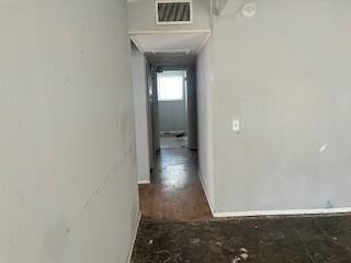 2413 46th Street Lubbock, TX 79412 - Photo 13 of 18 a view of a hallway with wooden floor and a bathroom