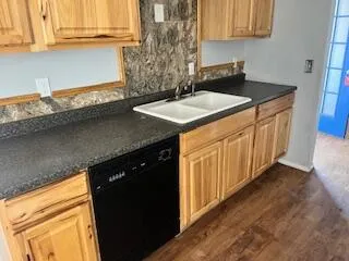 a kitchen with granite countertop a sink and a stove