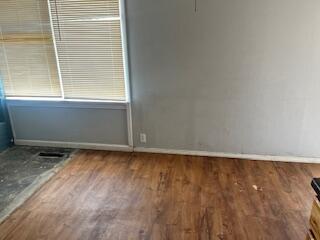 2413 46th Street Lubbock, TX 79412 - Photo 5 of 18 a view of a small space with wooden floor and a window