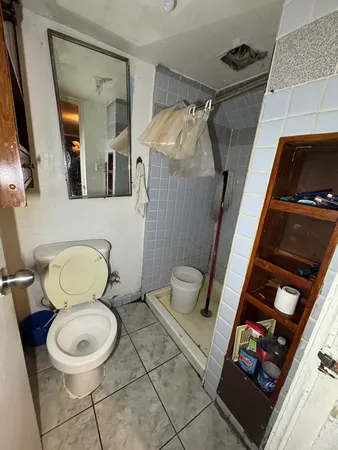 a bathroom with a toilet a sink and a mirror