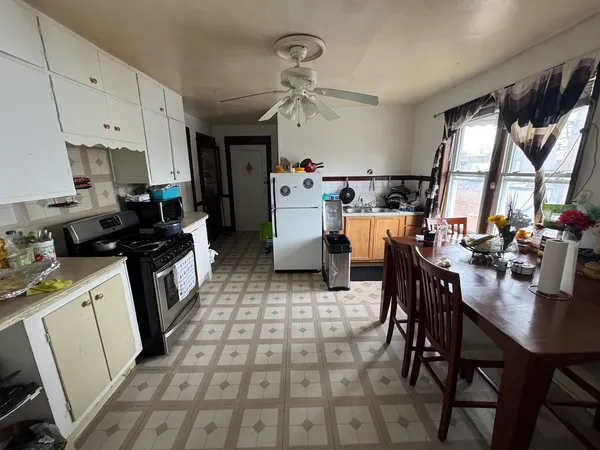 a kitchen with a dining table and chairs