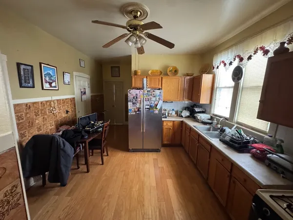 a kitchen with granite countertop a refrigerator stove and sink