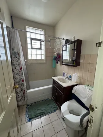 a bathroom with a toilet sink and mirror