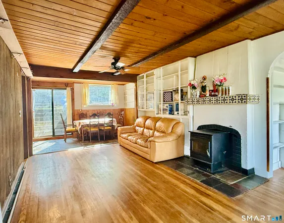 a living room with furniture a fireplace and a table