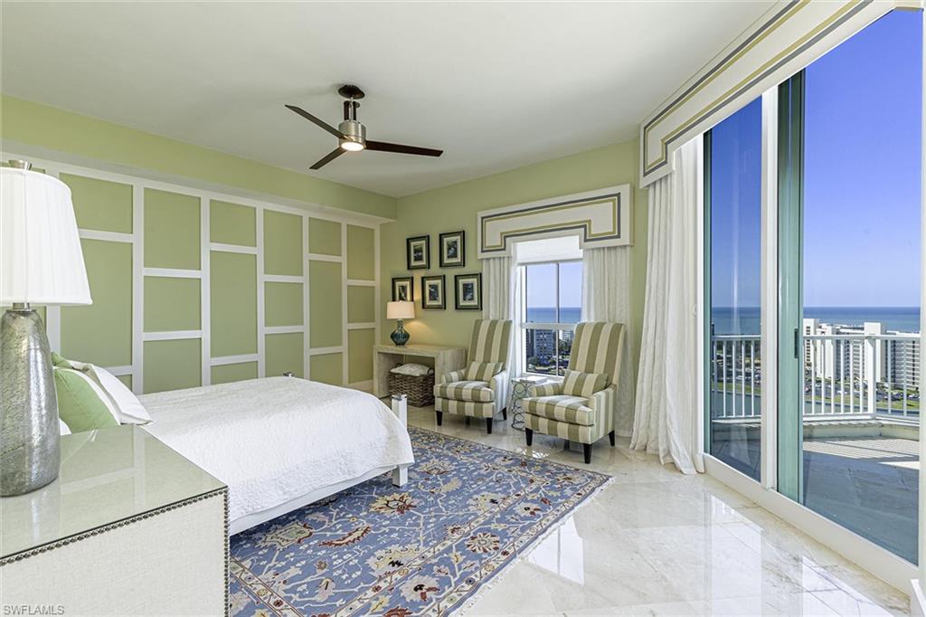 295 Grande Way, Unit PH2 Naples, FL 34110 - Photo 17 of 45 a bedroom with a large bed and a window