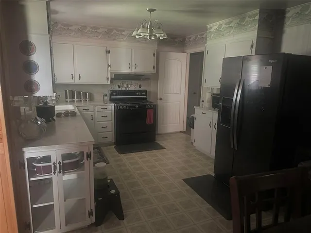 a kitchen with cabinets and stainless steel appliances
